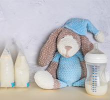 teddy bear with expressed milk in a bottle